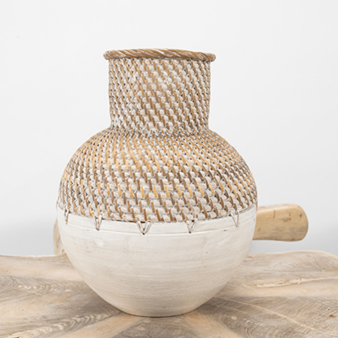 Handmade woven ceramic vase displayed in a styled interior setting