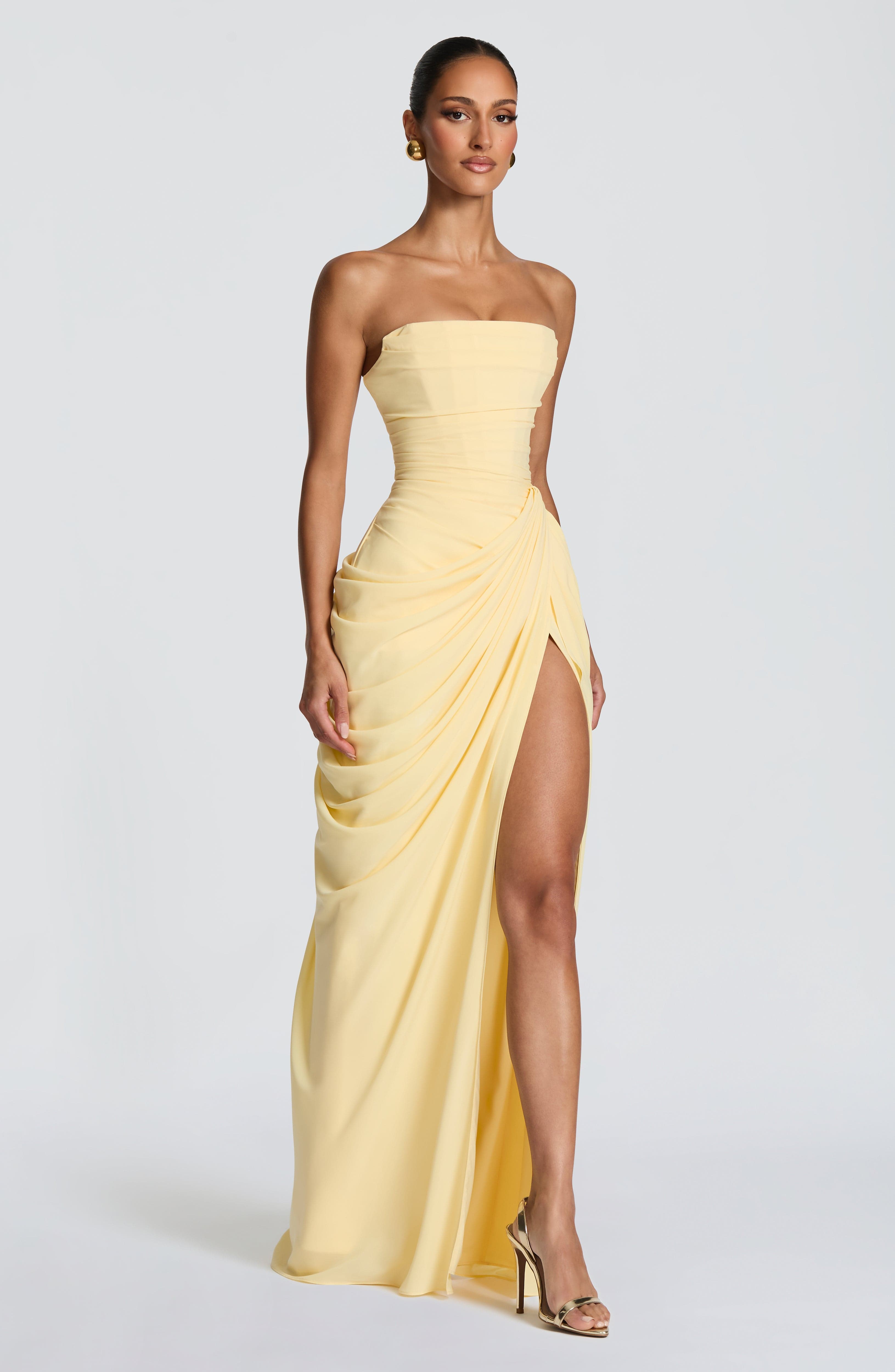 Women's form-fitting strapless maxi dress with gathered hip draping and structured bodice