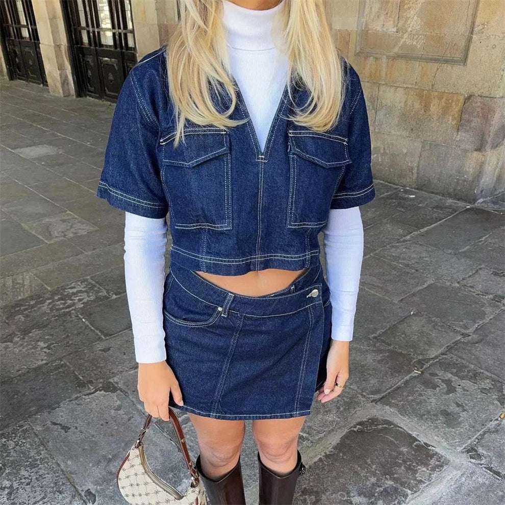 Two-piece denim outfit with panel construction detailing on cropped top and mini skirt
