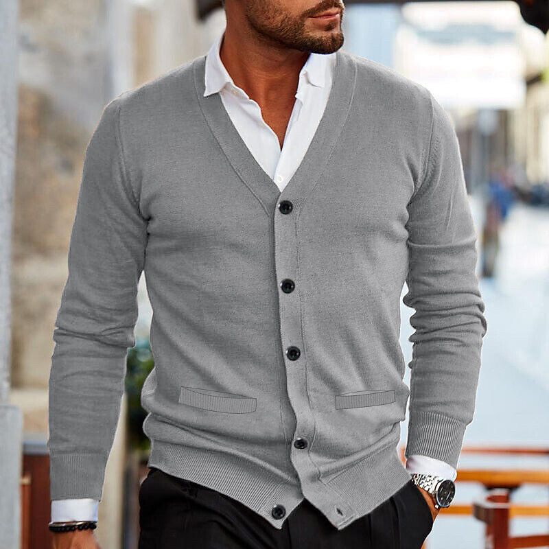 Close-up of front button closure and V-neckline on men's dark navy cardigan