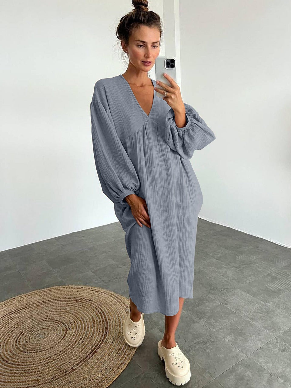 Women's loose midi dress with V-neckline, gathered front detail, long sleeves with elastic cuffs, and a straight hem