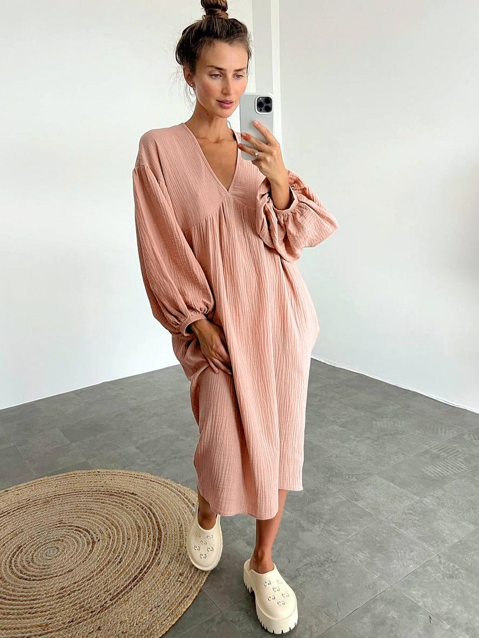 Women's midi-length dress with V-neckline, gathered front, and elastic cuffs in a relaxed, flowing fit
