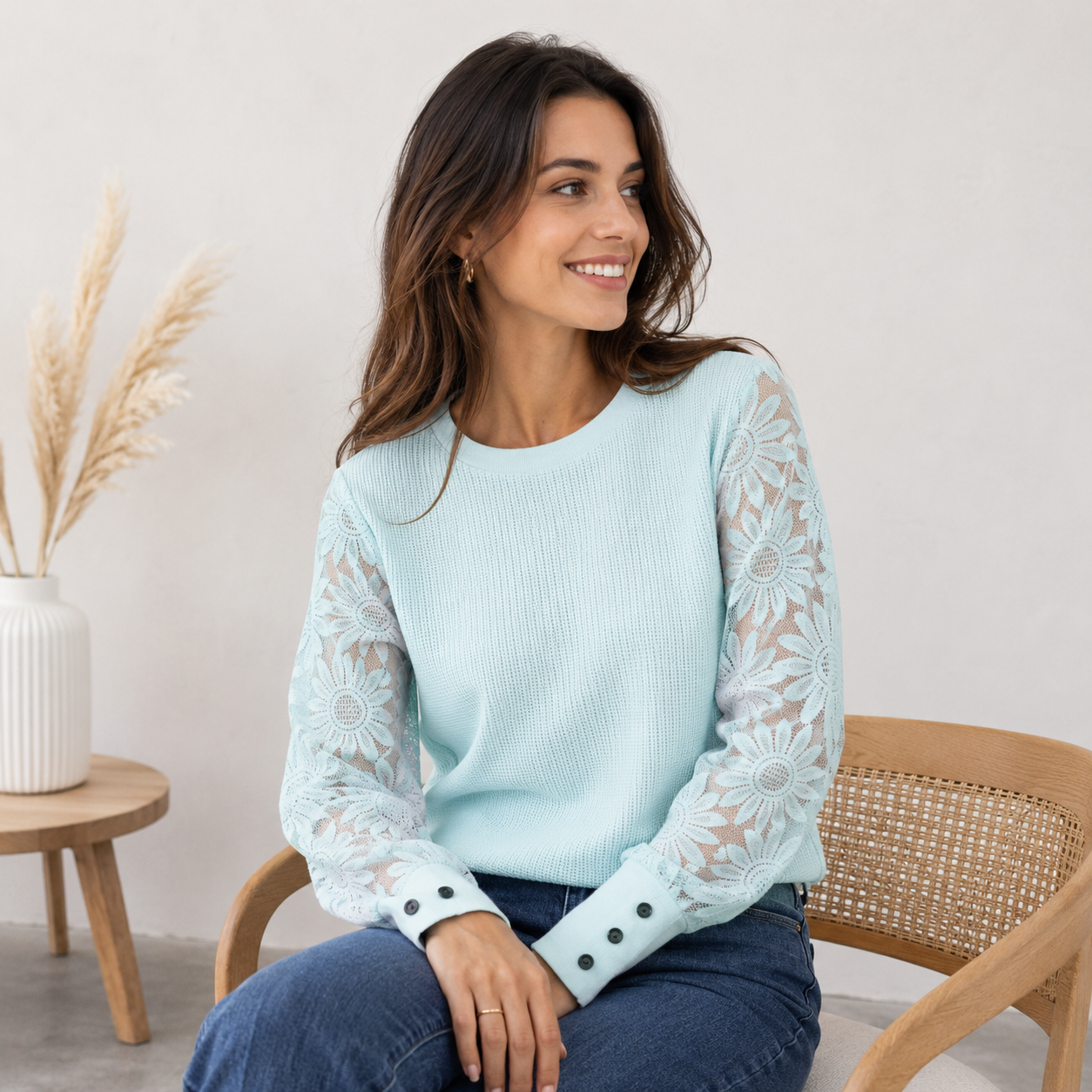 Women's long-sleeved lace sleeve top with round neckline, knit construction, and slim silhouette