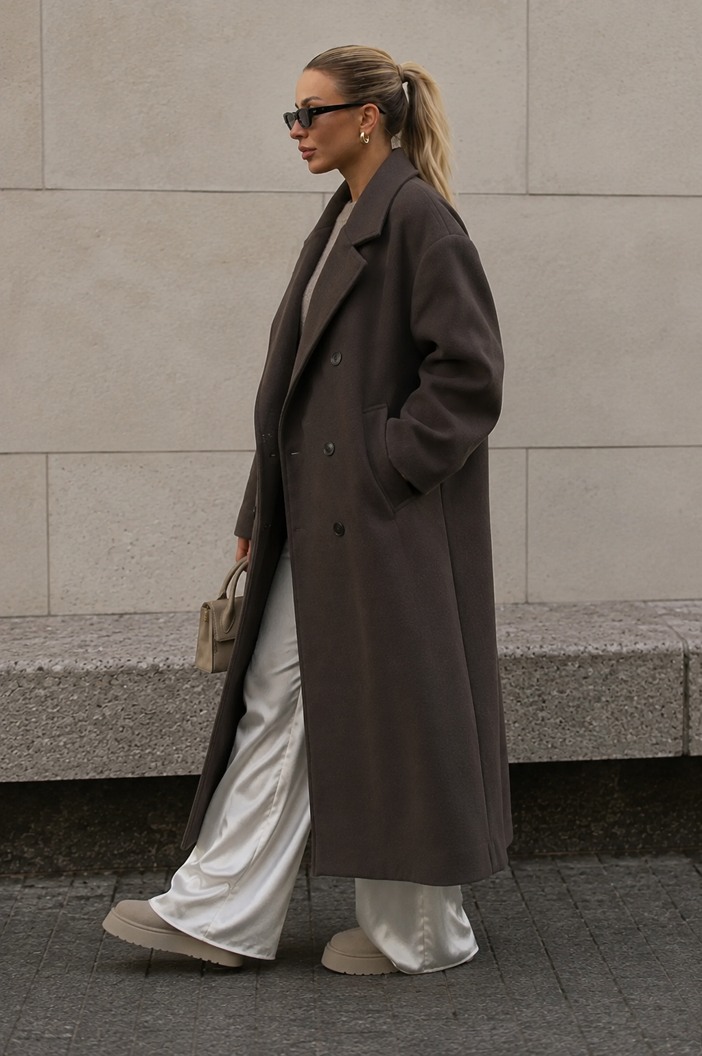 Women's long wool blend coat with wide lapels and double-breasted button closure, three-quarter view
