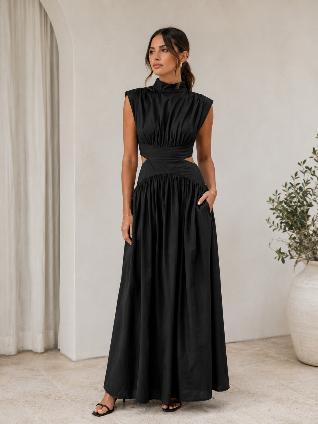 Full-length women's dress with fitted bodice, cut-out waist detail, and high neckline