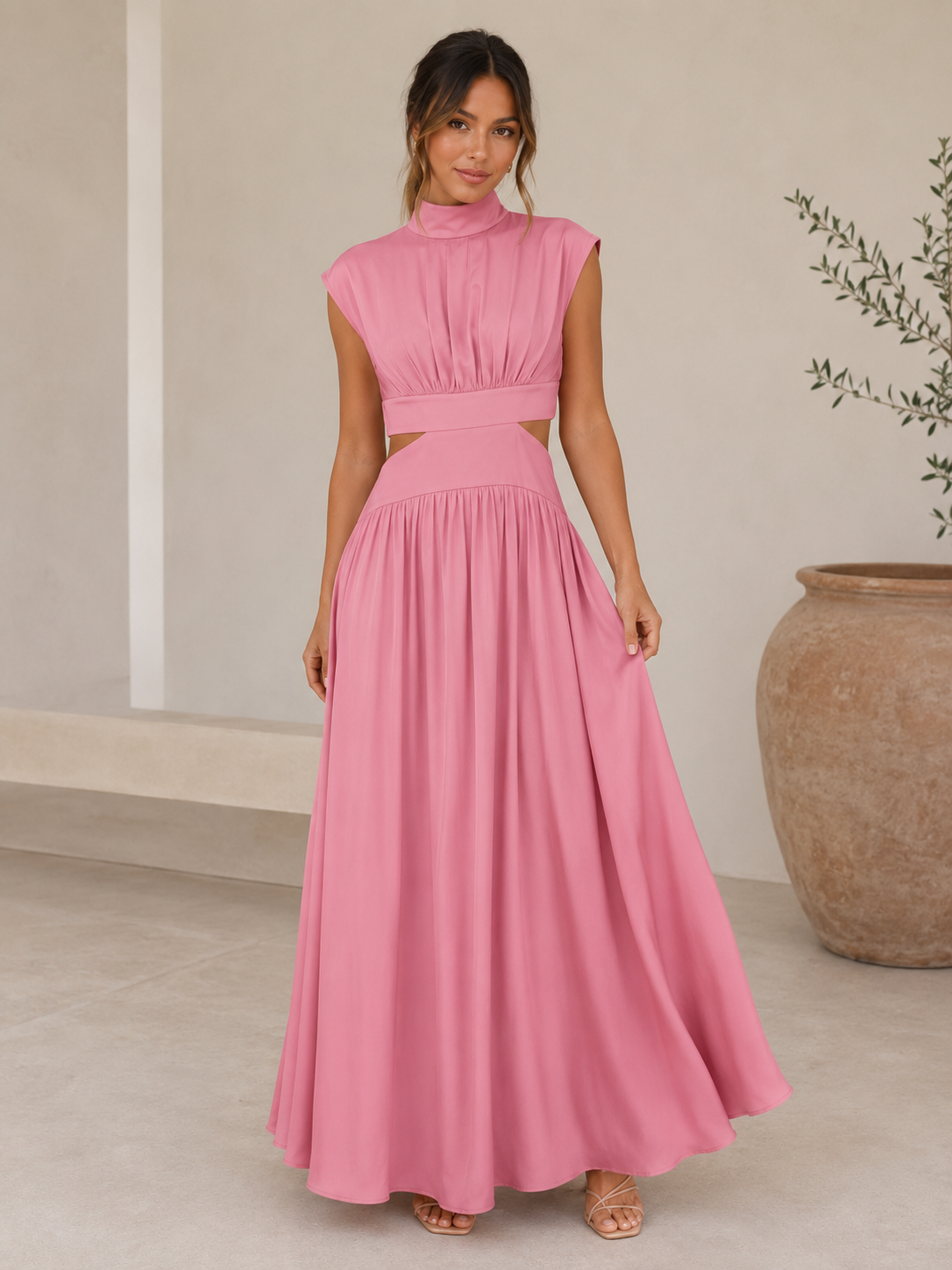 Long women's dress with high neck, waist-defining cut-out, and flowing full-length skirt