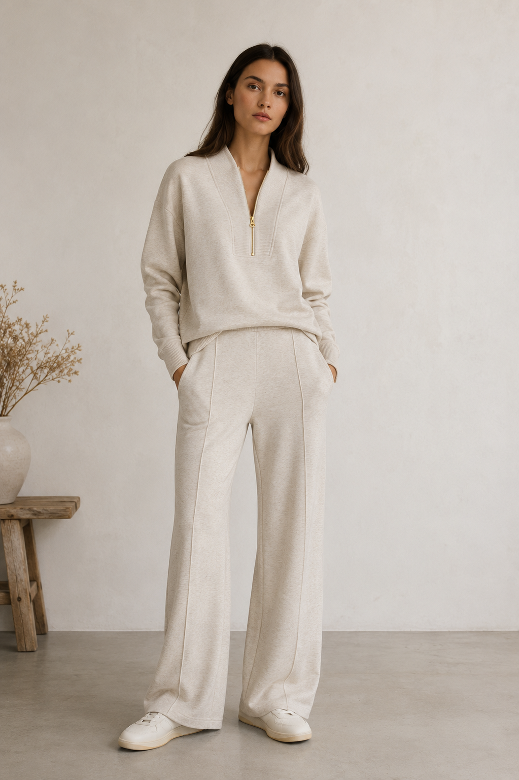 Women's two-piece knitted lounge set featuring a zip neck top and matching wide-leg trousers