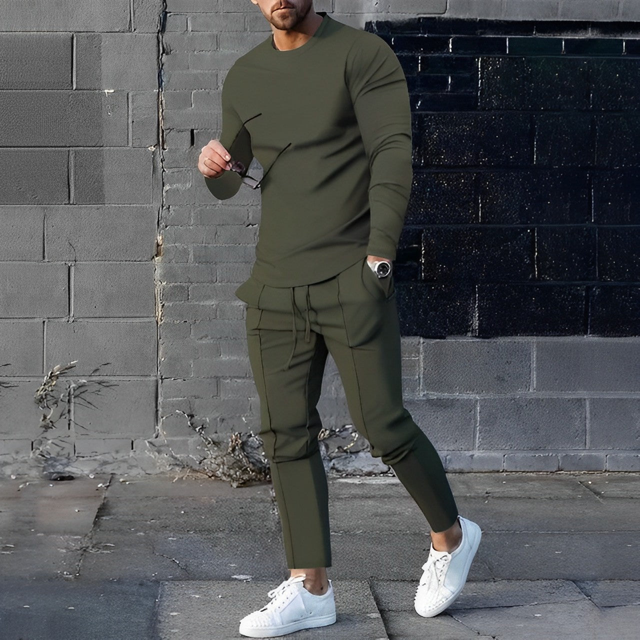 Men's training set styled on model — coordinated sweater and jogger set, slim silhouette