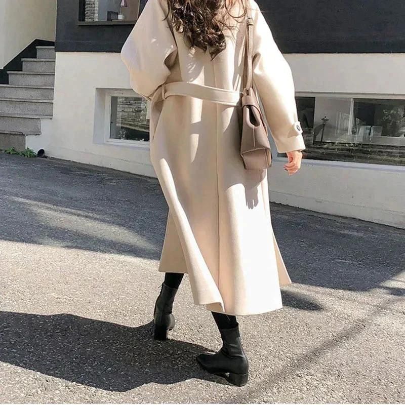 Women's relaxed-fit long coat with button front and turn-down collar, side profile view
