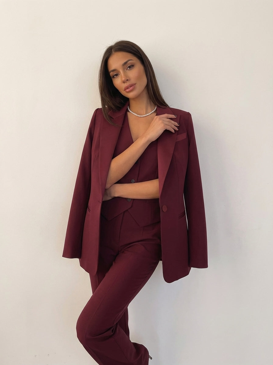 Structured women's blazer with lapel collar and single-breasted button closure from a three-piece suit set