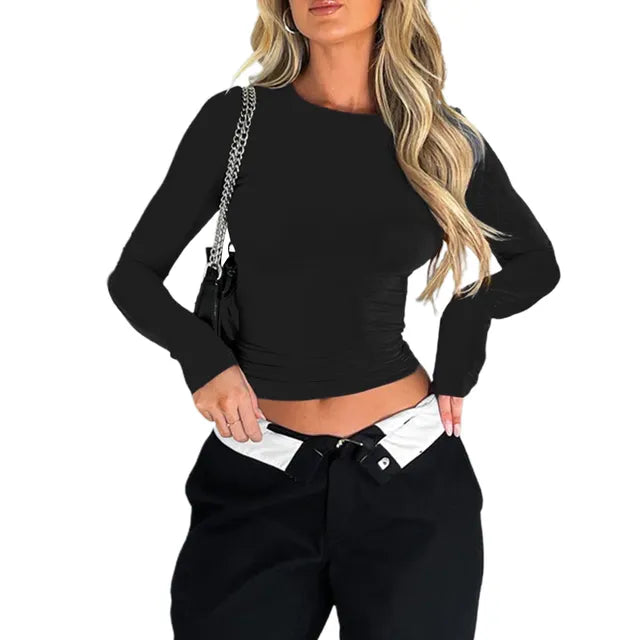 Women's form-fitting long-sleeve crop top with smooth stretch fabric and cropped length