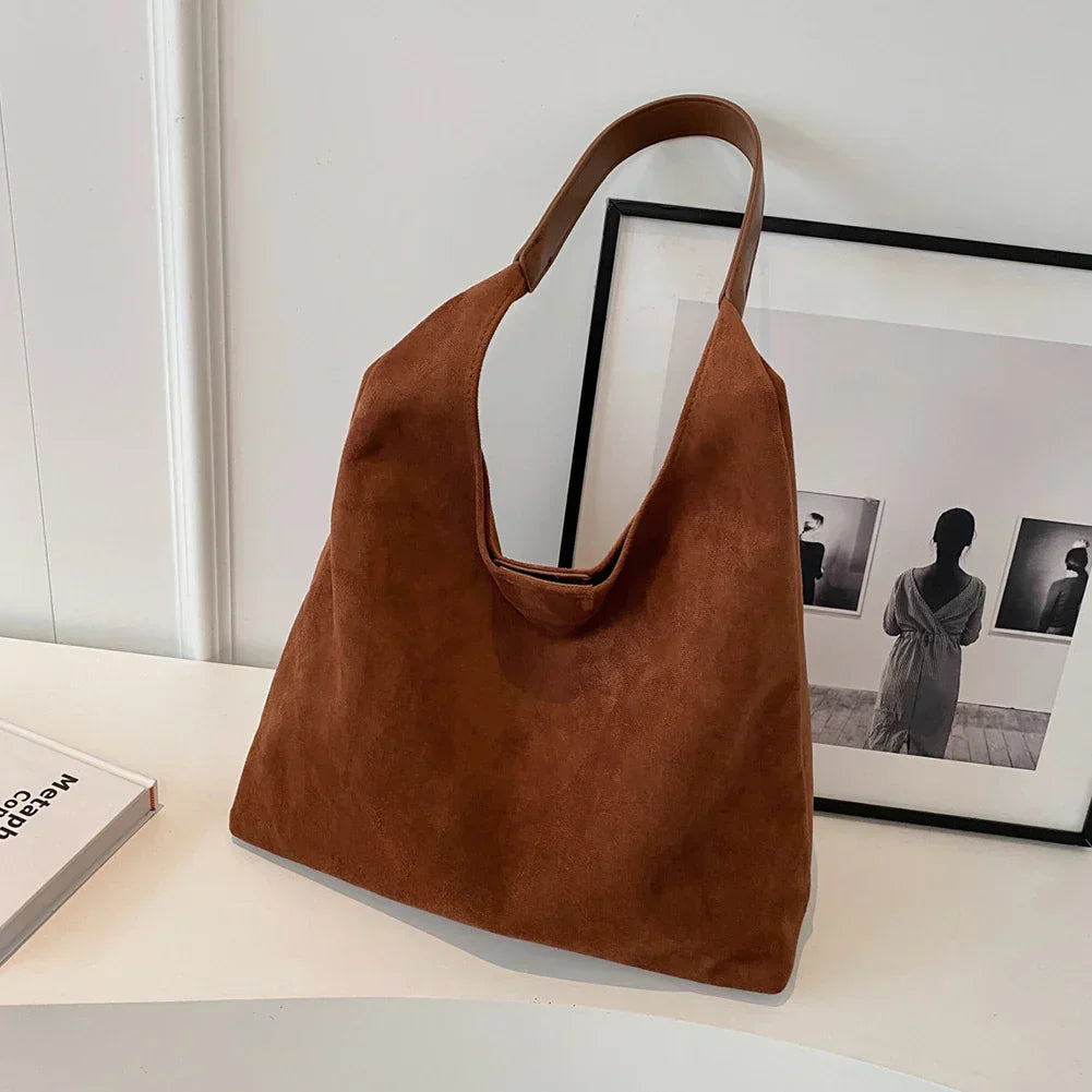 Minimalist tote bag with wide shoulder strap and structured silhouette