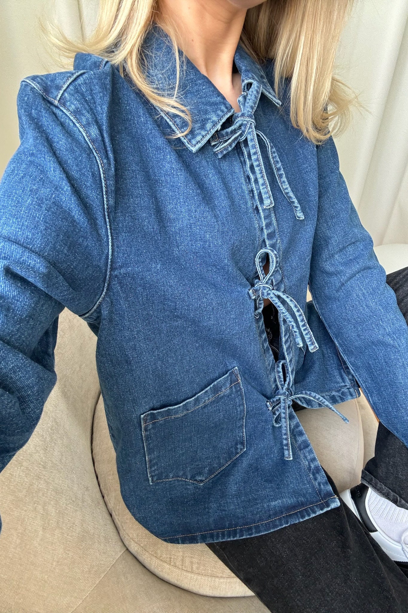 Women's washed denim jacket with front tie closure and patch pockets