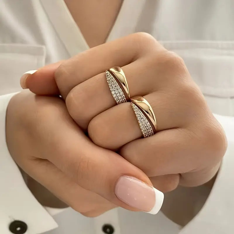 Two-piece metal ring set with decorative detailing, worn on hand