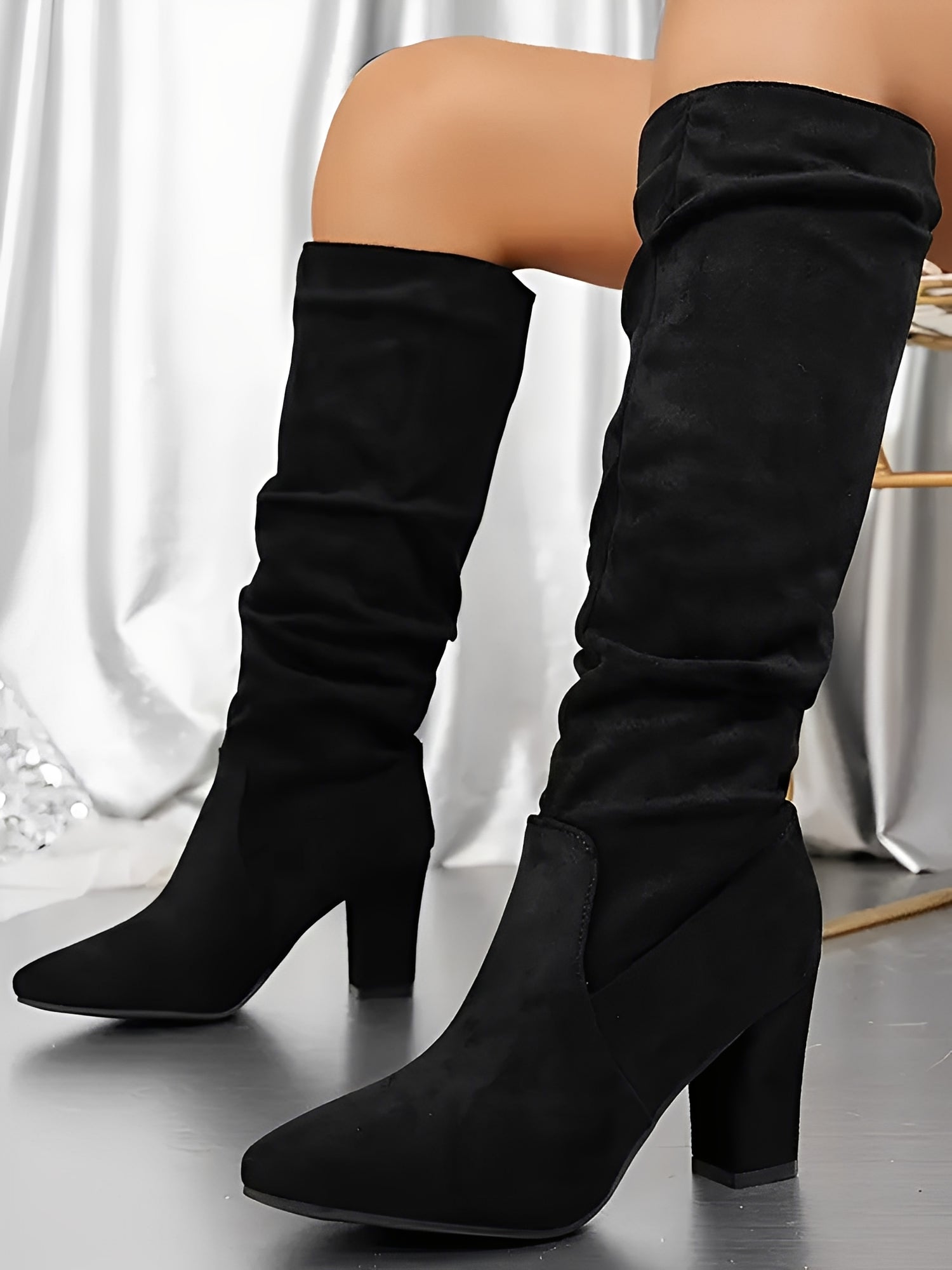 Women's knee-high faux suede boots showing toe box shape and overall silhouette
