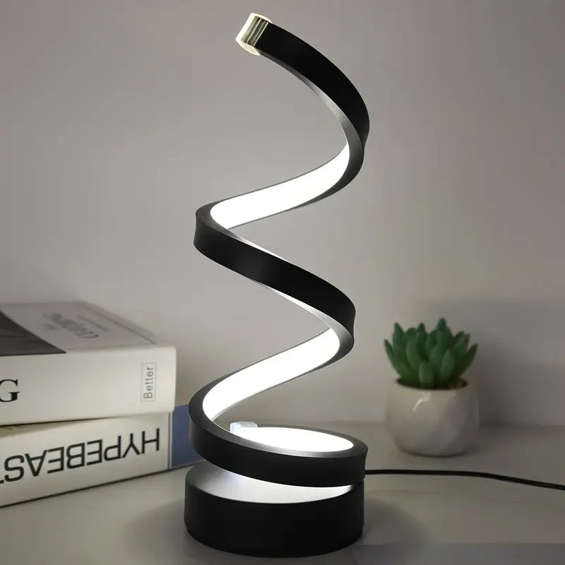 Sculptural spiral LED table lamp casting soft warm light as a decorative home accent