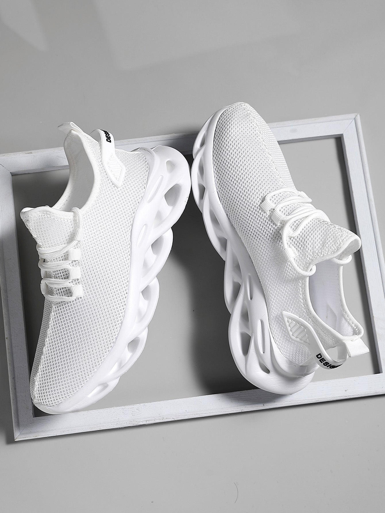 Men's round-toe sneaker in breathable mesh with lace closure, rear three-quarter view