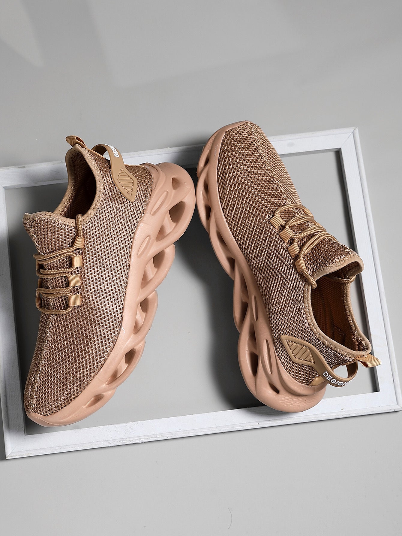 Men's lace-up sneaker in synthetic mesh, rear three-quarter view showing heel and sole construction