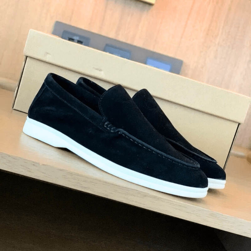 Pair of men's suede loafers shown at an angle highlighting the low-cut profile and smooth lining
