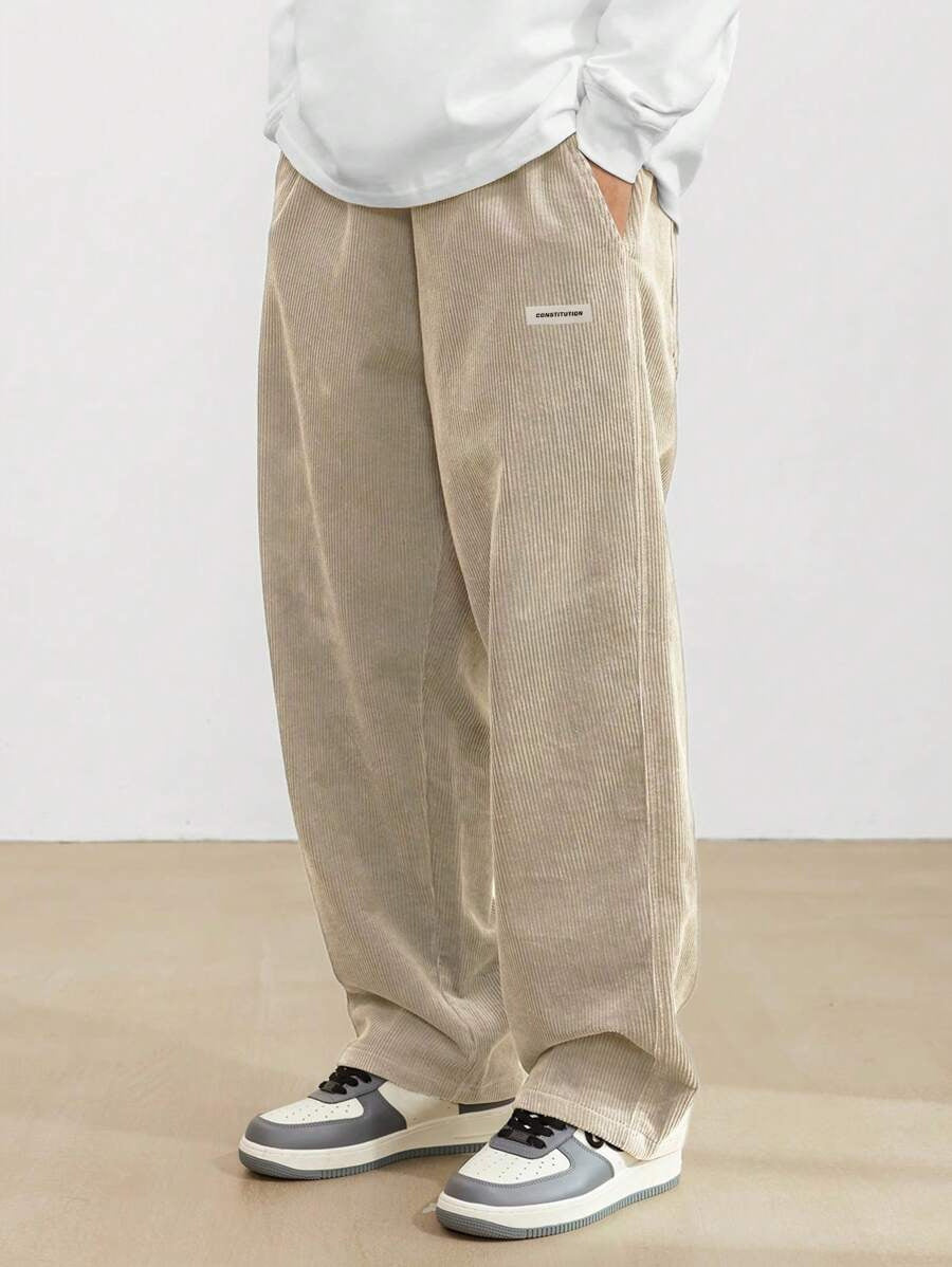Men's wide leg corduroy trousers shown from the front, elastic waist detail visible
