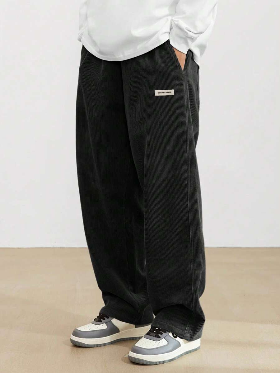 Wide fit men's corduroy trousers, side profile view showing relaxed leg width