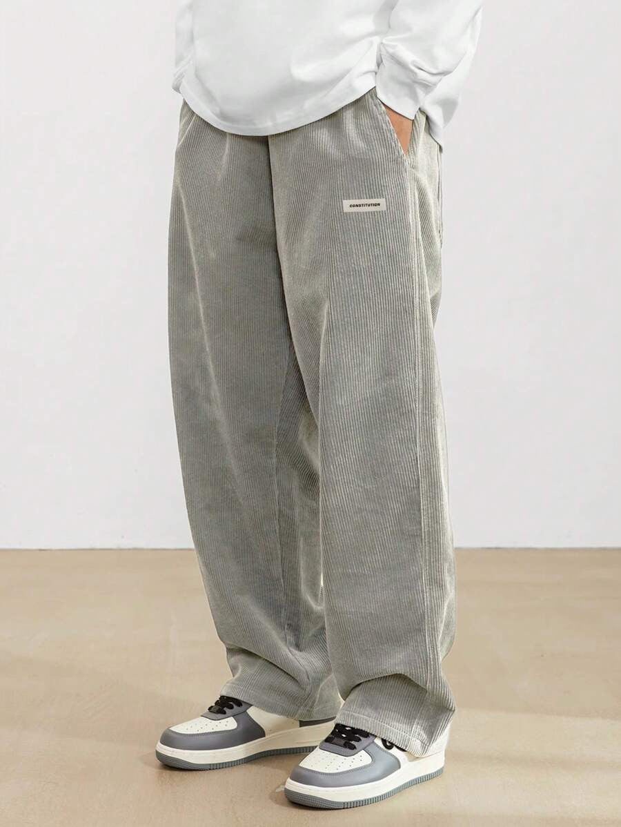 Men's corduroy trousers with wide silhouette, rear view showing full-length cut