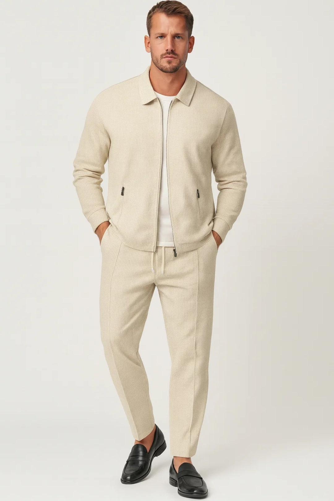 Men's two-piece textured set featuring a zip-up jacket with side pockets and matching tapered pants