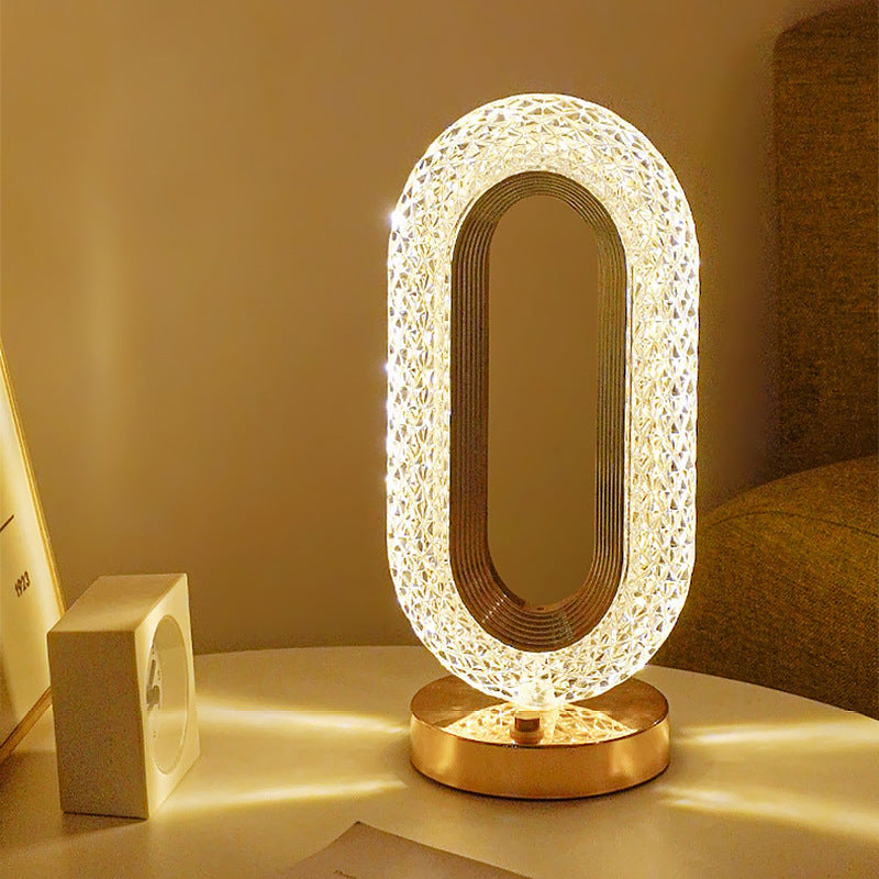 Acrylic LED table lamp emitting warm ambient glow through translucent oval frame