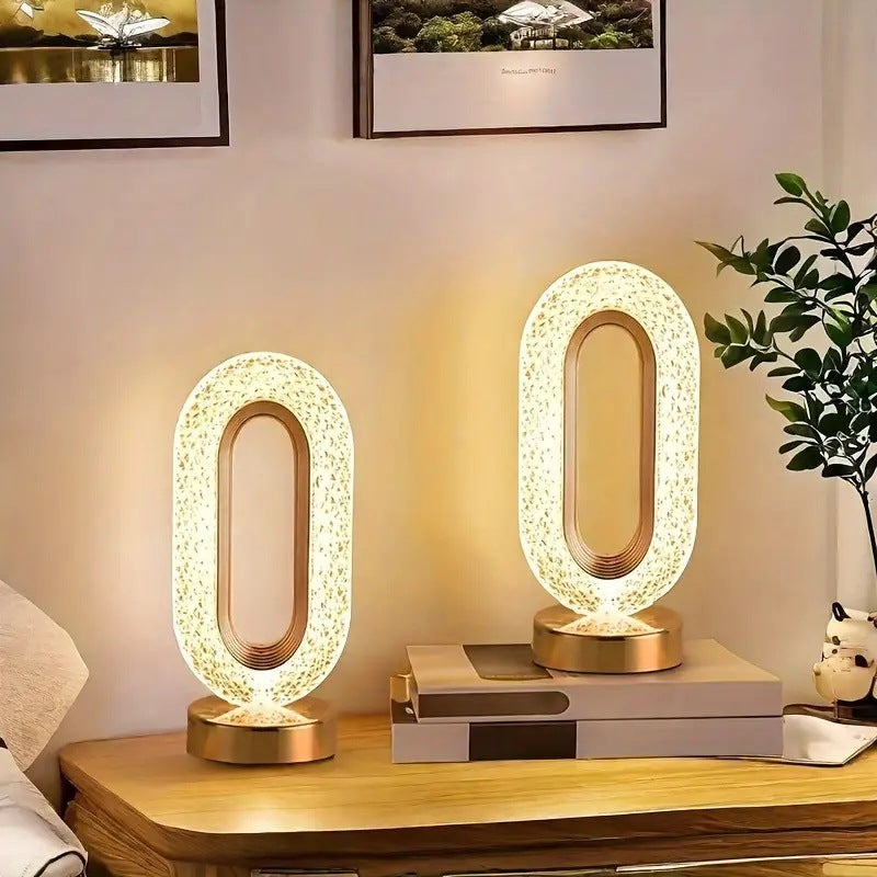 Modern LED table lamp placed on a surface in a living room or bedroom setting