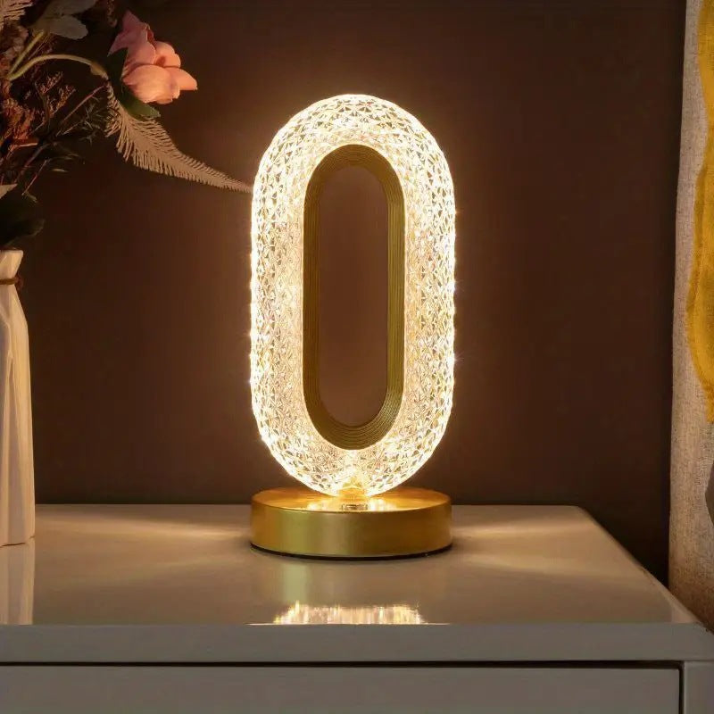 Acrylic LED table lamp showing base and frame structure from an angled view