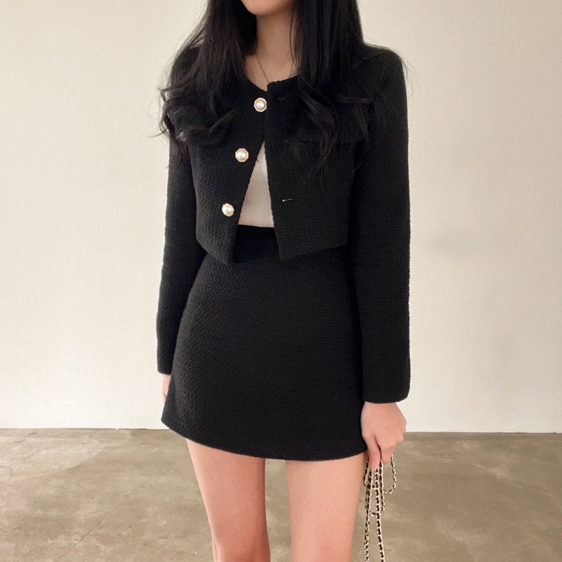 Women's two-piece set with cropped structured jacket and high-waisted straight mini skirt in textured woven fabric