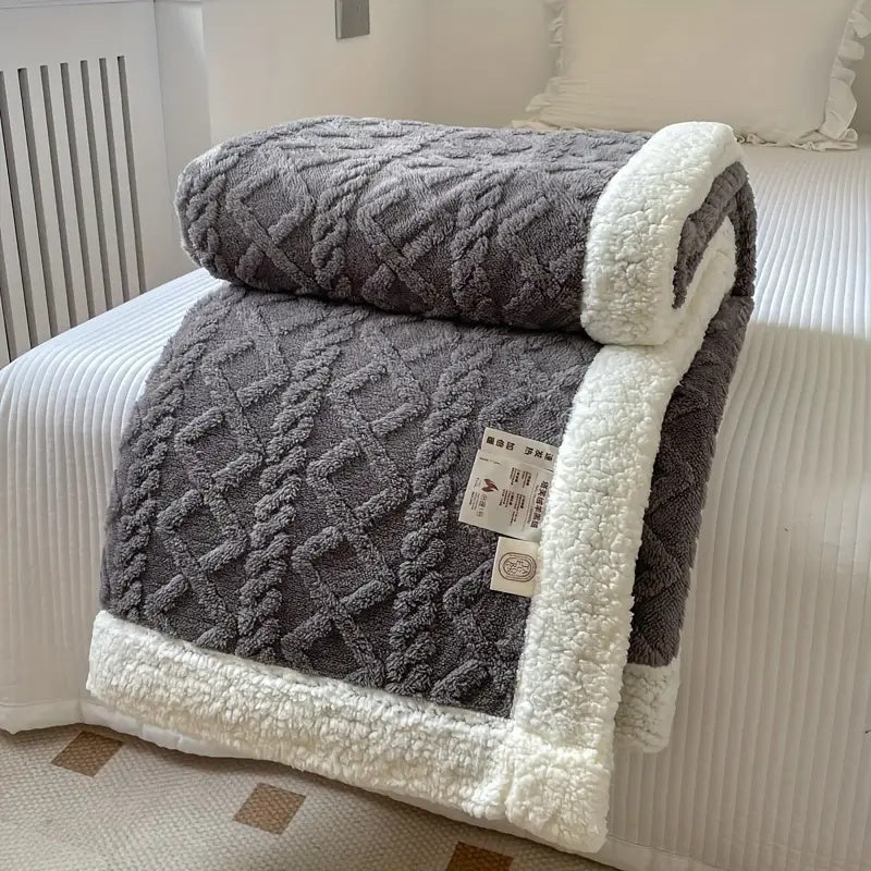 Luxurious plush blanket with sherpa lining laid flat, showing full textured surface pattern