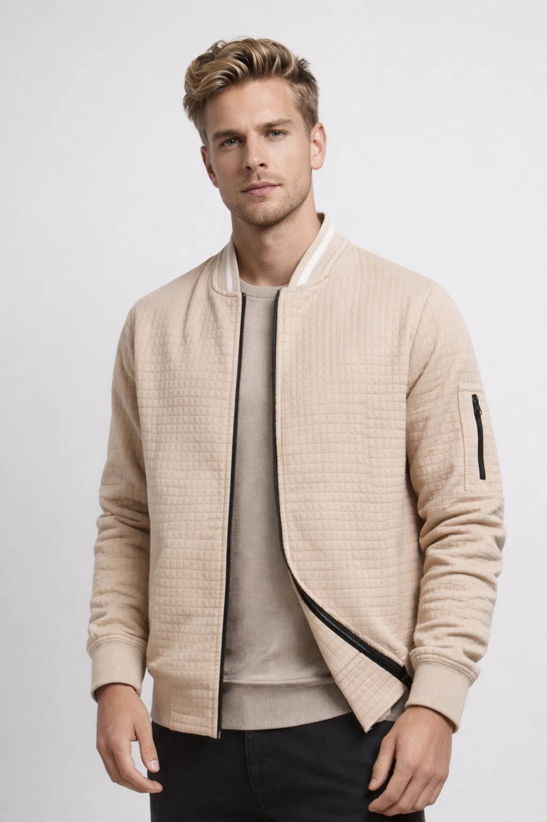 Men's quilted bomber jacket featuring ribbed hem, side pockets, and sleeve pocket