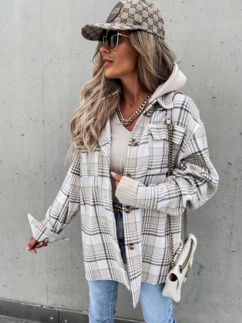 Women's plaid overshirt jacket flat lay or close-up detail of collar and button closure