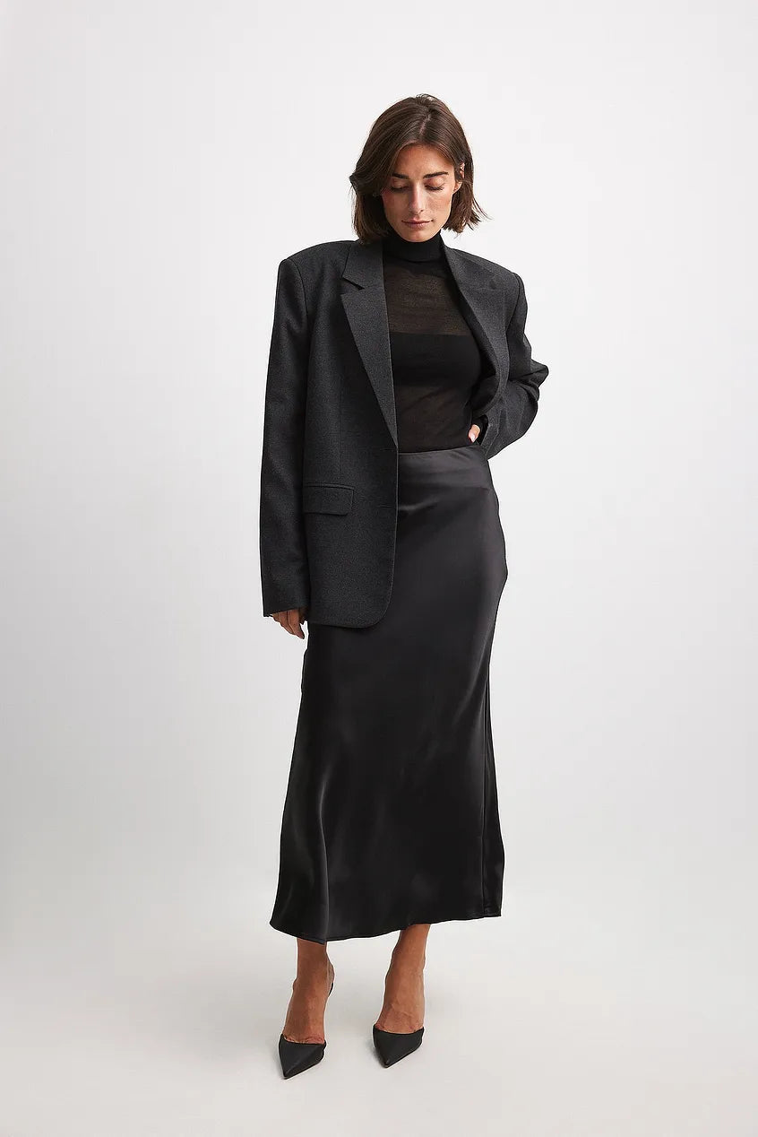 Satin midi skirt for women showing smooth fabric drape and midi length, side angle