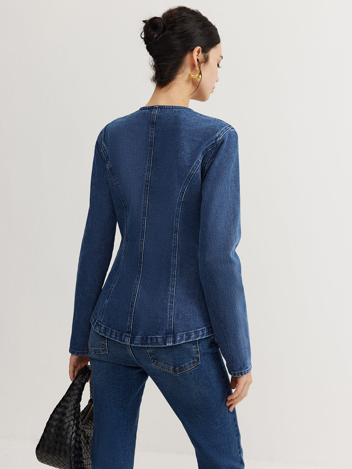 Women's structured denim jacket with marked seams and button front detail