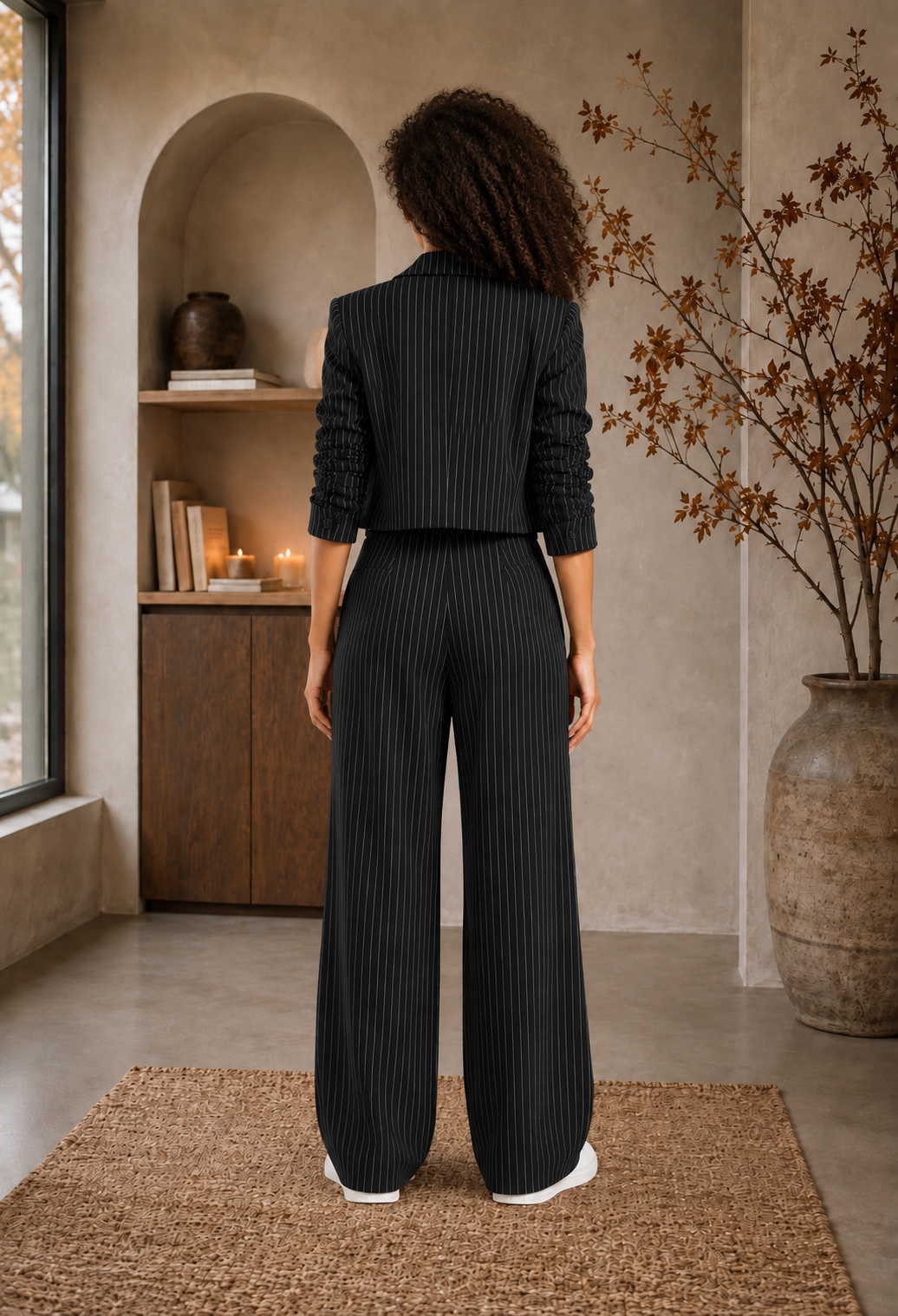 Women’s black pinstripe blazer and trousers set full-length back view