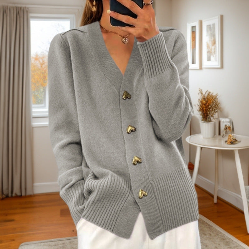 Women's knitted cardigan with ribbed edges and decorative button front, styled view