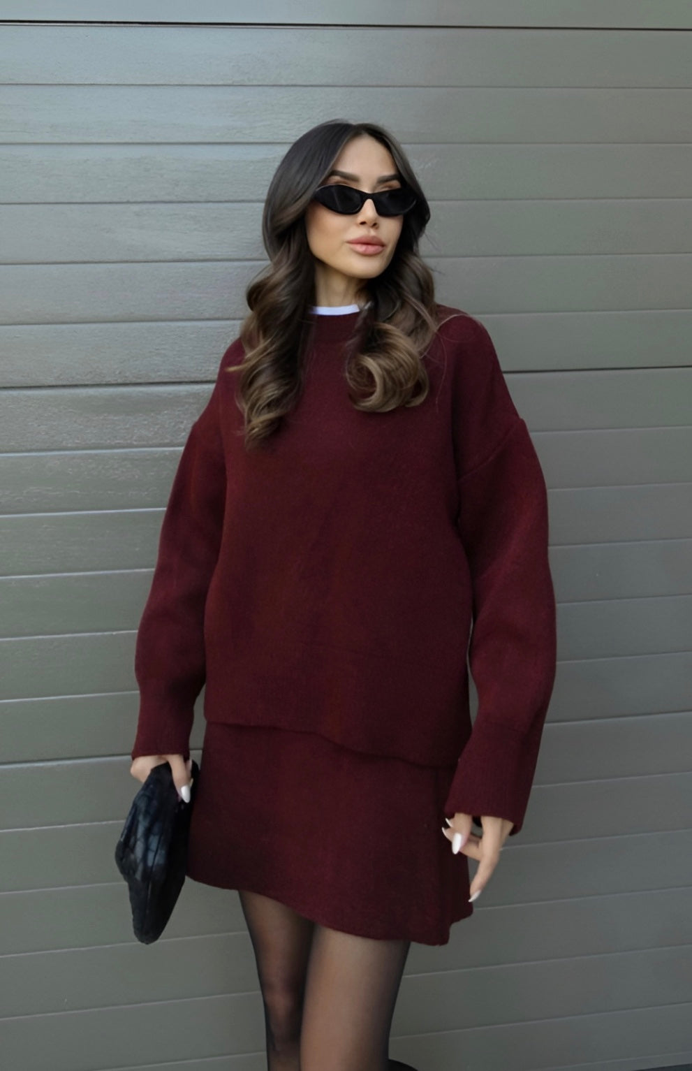 Women's knitted two-piece set featuring pullover sweater and elastic waist mini skirt, styled view