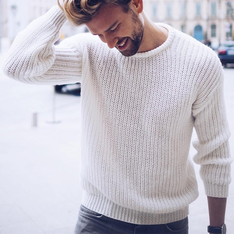 Men's chunky knit pullover sweater showing textured knit pattern, side view