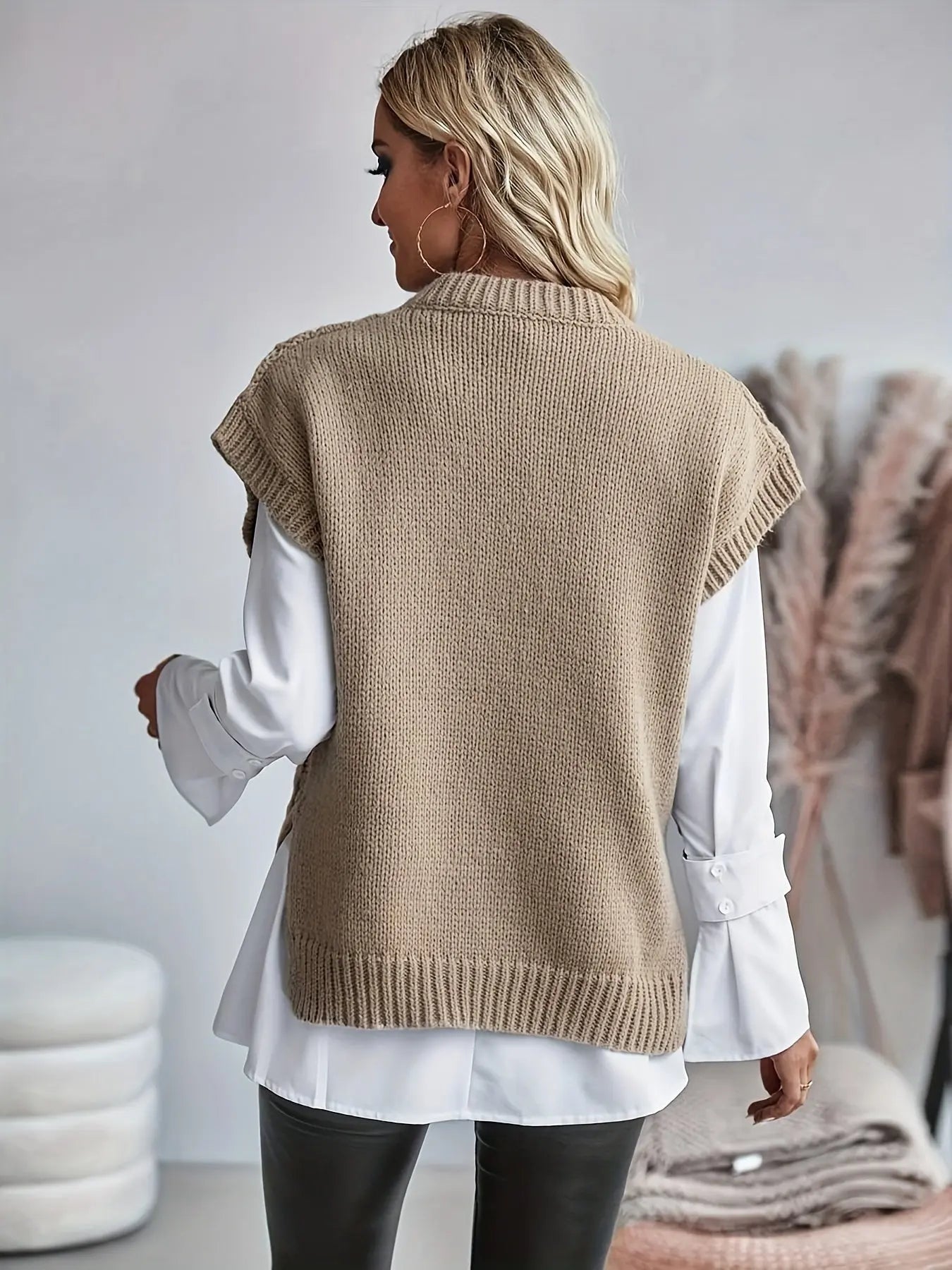 Cable knit sleeveless sweater for women showing back panel and structured knit texture