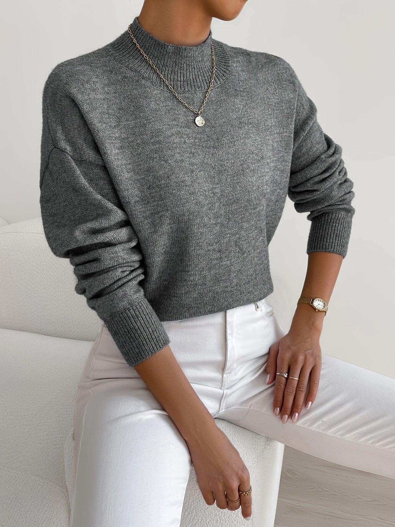 Relaxed fit knitted sweater for women with high neckline and ribbed hem