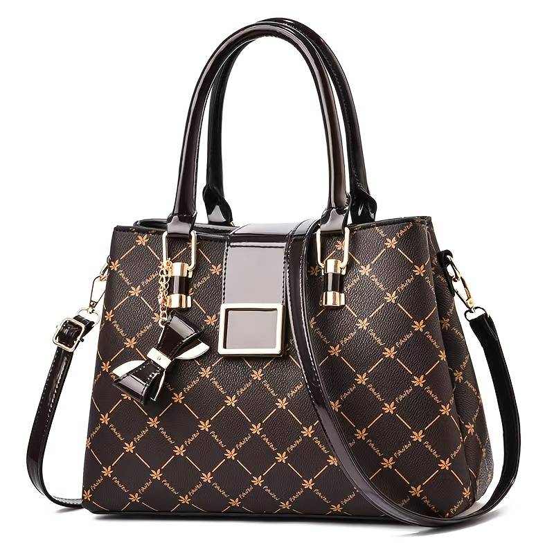 Women's patterned handbag worn with detachable shoulder strap for versatile everyday carry