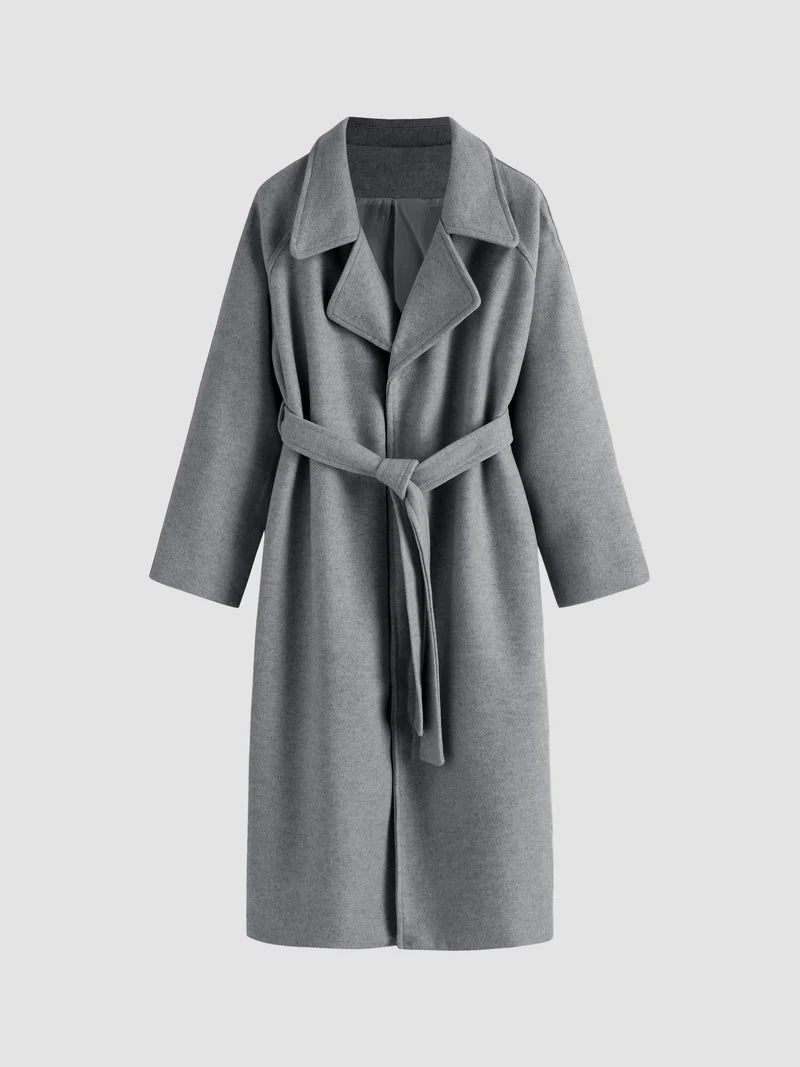 Women's long coat with belted waist, lapel collar, and full-length silhouette