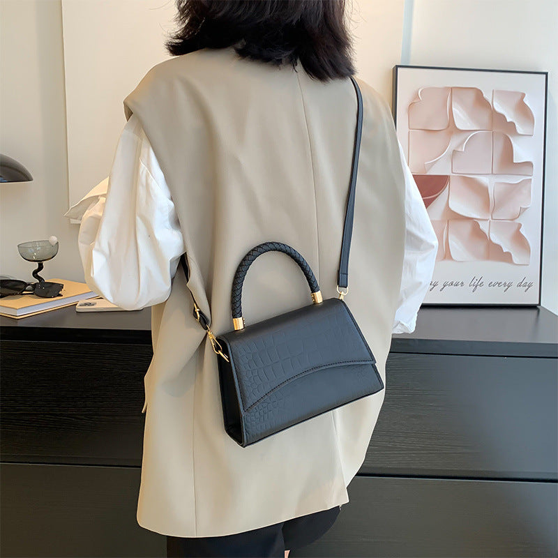 Structured handbag with croc-embossed faux leather texture and top zipper closure