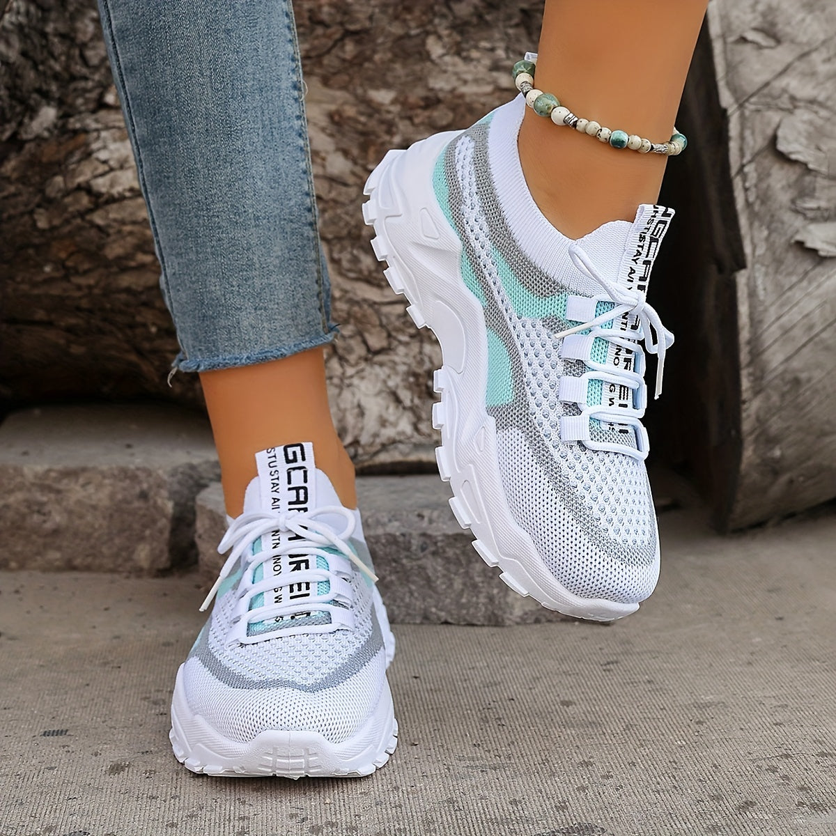 Close-up of breathable mesh upper and elastic sock collar on women's lightweight sneakers