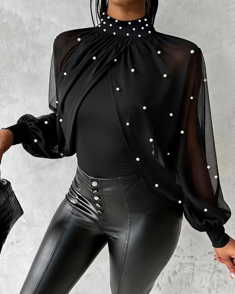 Women's transparent long-sleeve blouse with opaque inner layer, three-quarter front view