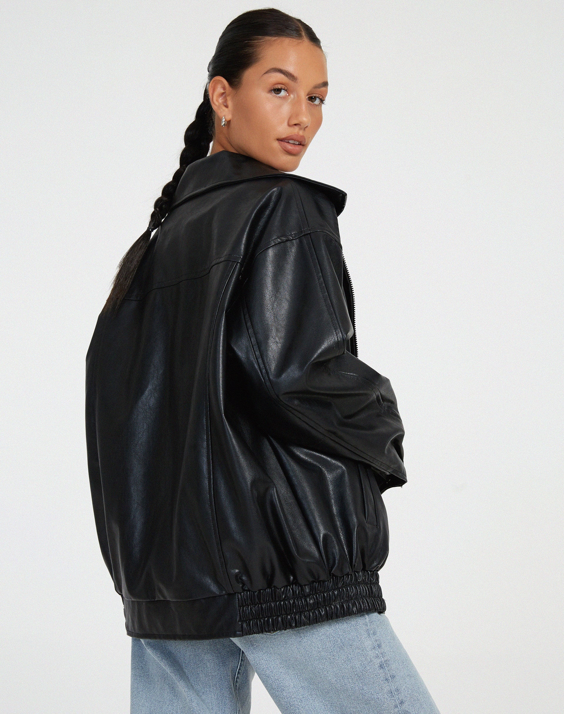 Full-length view of women's oversized vegan leather jacket with side pockets and clean front zipper