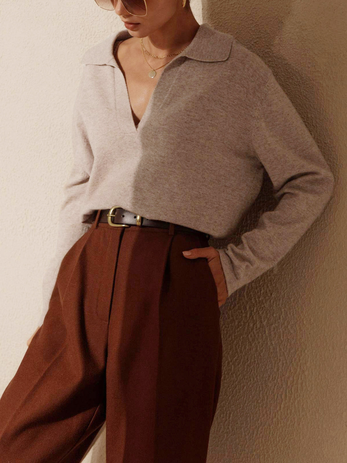 Women's fine knit top with soft collar and hip-length silhouette