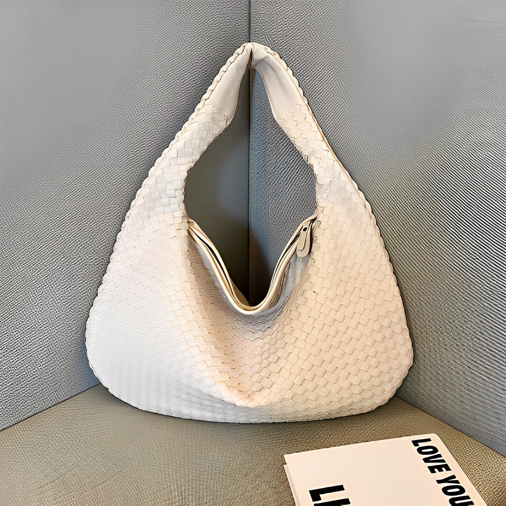 Woven faux leather women's shoulder bag showing structured body and wide shoulder strap